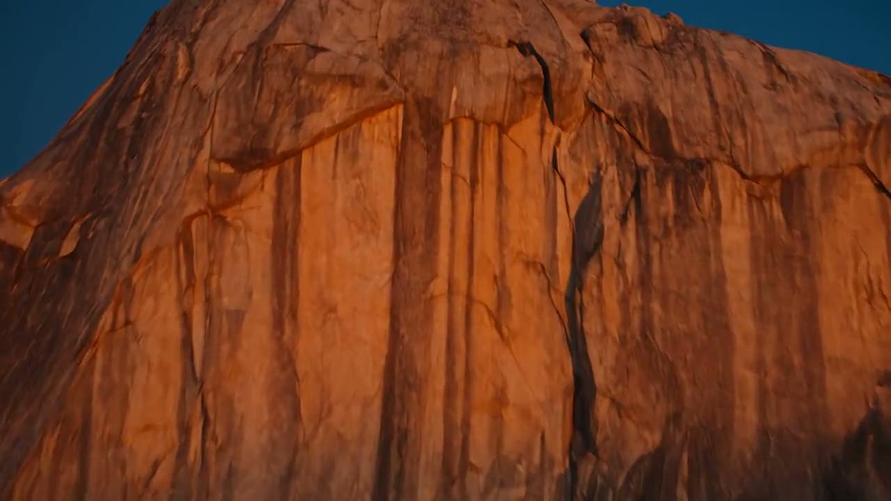 A granite face rising in low golden light